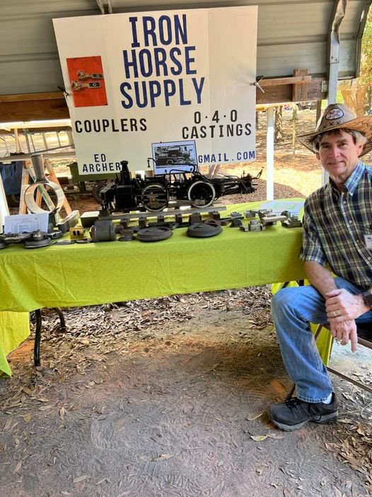 Ed Archer sitting at his vendor booth at the Ridge Winter Meet